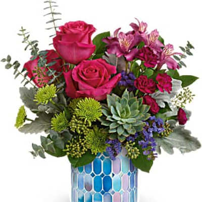Pink roses and mixed flowers in a blue mosaic vase