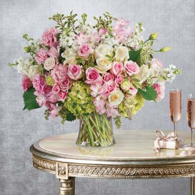 Pink and white mixed flower arrangement in a clear glass vase