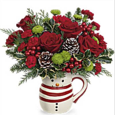 Red roses in a snowman mug with pinecones and holiday greenery