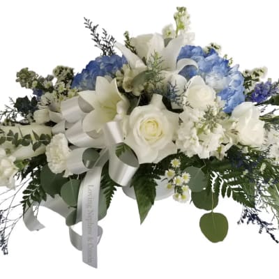 White and blue floral spray with a ribbon bow