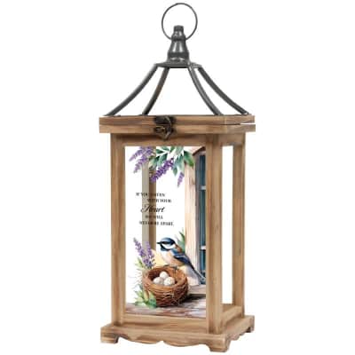 Wooden lantern with metal top and glass panel printed with bird, nest, eggs, and purple flowers