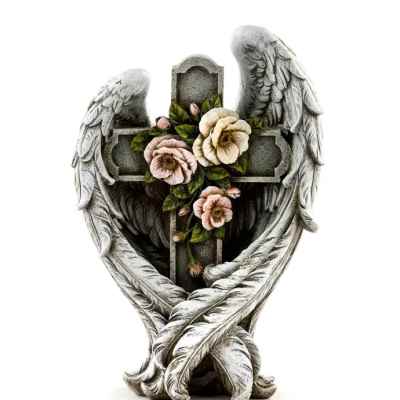 Stone cross framed by angel wings with carved pink and cream flowers in the center.