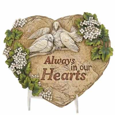 Heart-shaped memorial plaque with doves, small white blossoms, and the words Always in our Hearts.