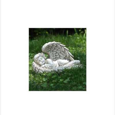 White sleeping angel statue lying on grass
