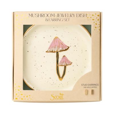 Boxed mushroom jewelry dish with pink mushroom illustration and small gold stud earrings.