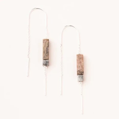 Pair of minimalist long silver chain earrings with rectangular stone beads on a light background