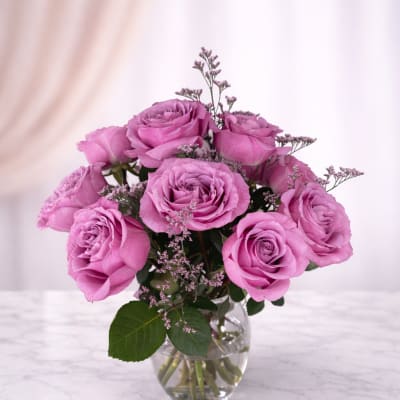 Pink roses arranged in a clear glass vase