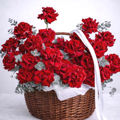 Basket of red roses with a white ribbon