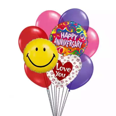 Cluster of colorful anniversary balloons with smiley and love messages