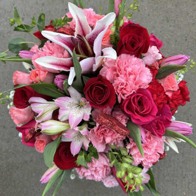 Bouquet of pink and red roses, lilies, and carnations