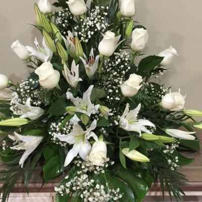 White roses and lilies arranged in a large spray