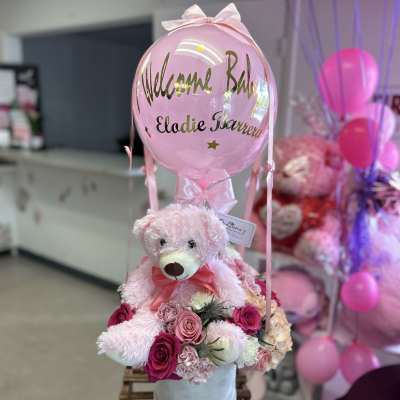 Pink teddy bear with roses and a pink balloon topper
