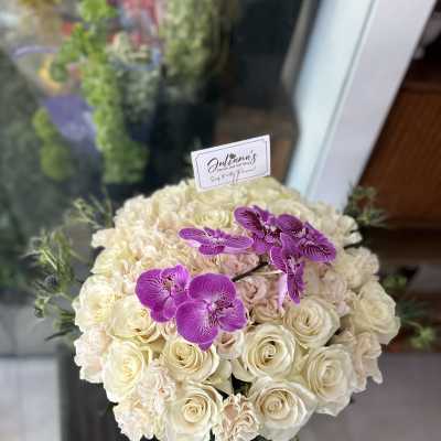 Cream rose bouquet with purple orchids