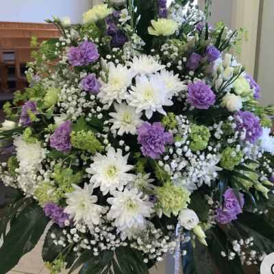 Large funeral spray with white and purple flowers