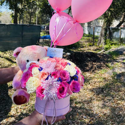 Pink rose bouquet with a teddy bear and pink balloons in a round box