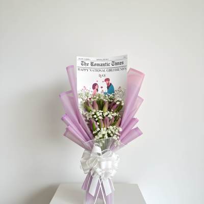 Lavender-wrapped bouquet with pink tulips and white baby's breath