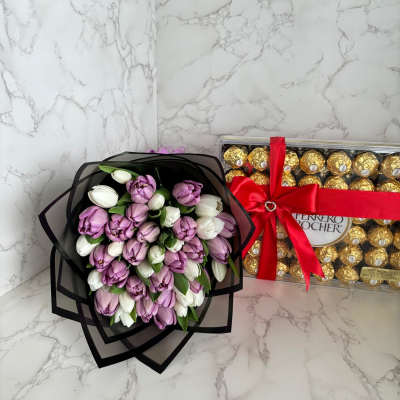 Bouquet of purple and white tulips beside a Ferrero Rocher chocolate box