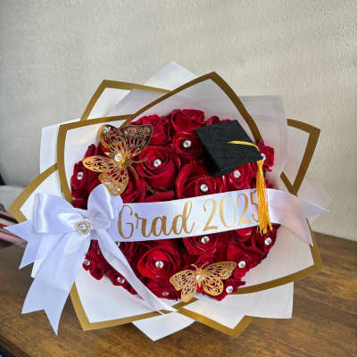 Red rose bouquet with a graduation cap and ribbon