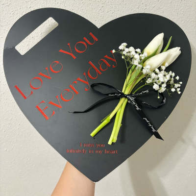 Heart-shaped black memorial box with white tulips and baby's breath