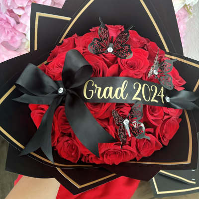 Red rose bouquet with black wrapping and a "Grad 2024" ribbon
