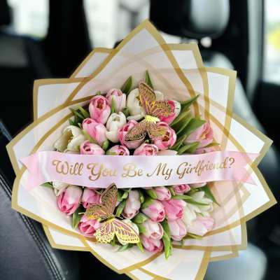 Pink and white tulip bouquet with a "Will You Be My Girlfriend?" ribbon