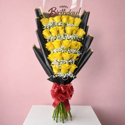Bouquet of yellow roses with a birthday topper and red ribbon