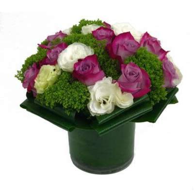 Pink and white roses arranged in a green vase