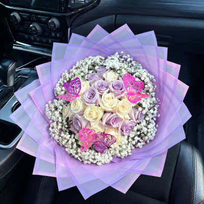 Lavender and cream rose bouquet with baby’s breath and pink butterfly picks