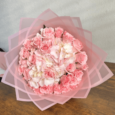Pink rose bouquet wrapped in translucent pink paper