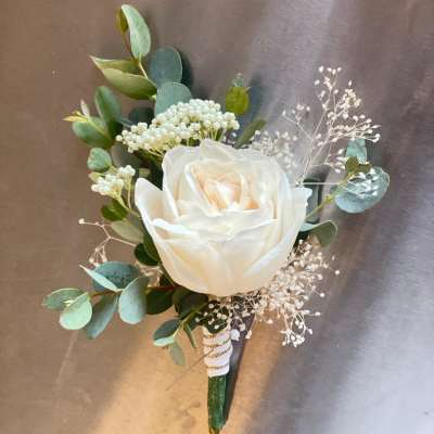 White rose boutonniere with eucalyptus and baby's breath