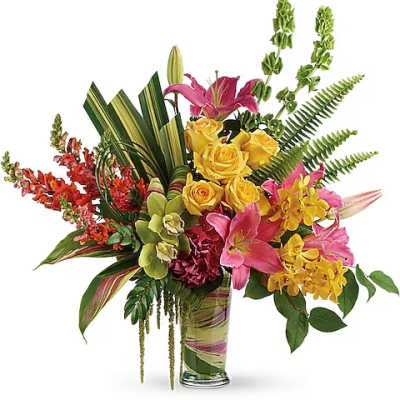 Tropical bouquet with pink lilies, yellow roses, and orchids in a glass vase