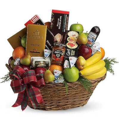 Gift basket with fruit, chocolates, and a plaid ribbon