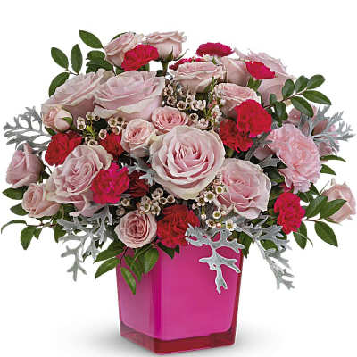 Pink and red rose bouquet in a bright pink vase