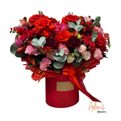 Red and pink rose bouquet in a red hat box