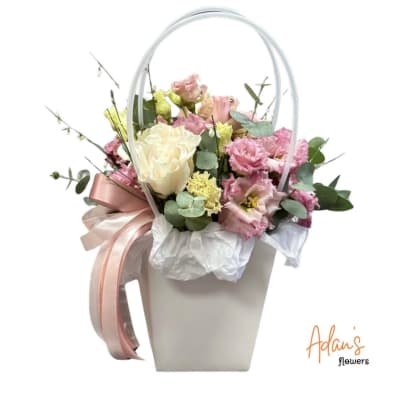 Pink and white bouquet in a white handled box with ribbon