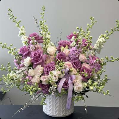 Lavender and blush roses in a white textured vase