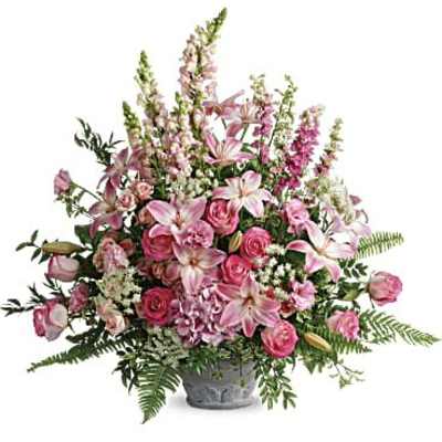 Large pink arrangement of lilies, roses, and snapdragons in a gray urn-style container