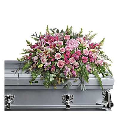 Pink and white casket spray with roses and lilies arranged on a silver casket