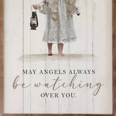 Wood-framed wall art of a childlike angel holding a lantern with the words may angels always be watching over you.