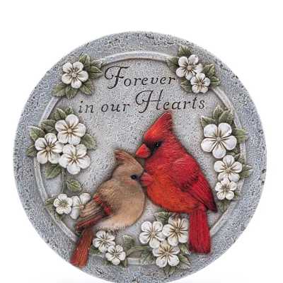 Round stone plaque with two cardinals and white flowers around the words Forever in our Hearts