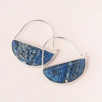 Pair of silver earrings with semicircle blue stone insets on a light background