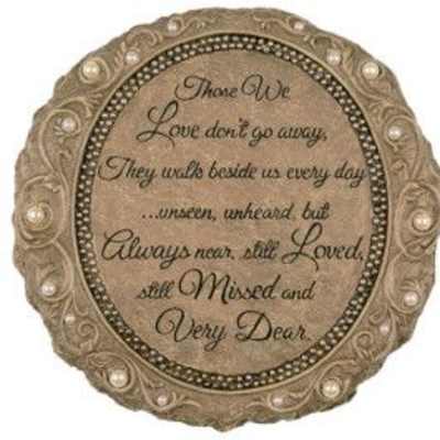 Round decorative memorial plaque with ornate border and sympathy verse in script text