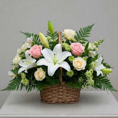 Basket arrangement of white lilies and pink and cream roses