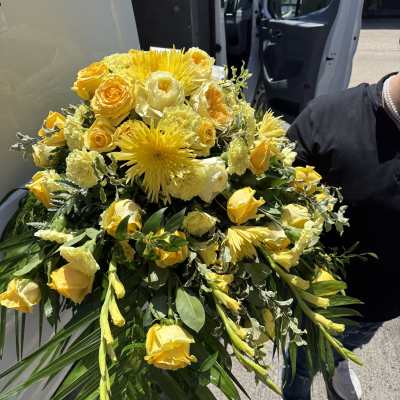 Yellow Yolk Sunrise Casket Spray