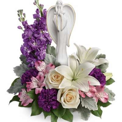 Sympathy arrangement with white angel figurine, white lilies, cream roses, purple and pink flowers in a low design