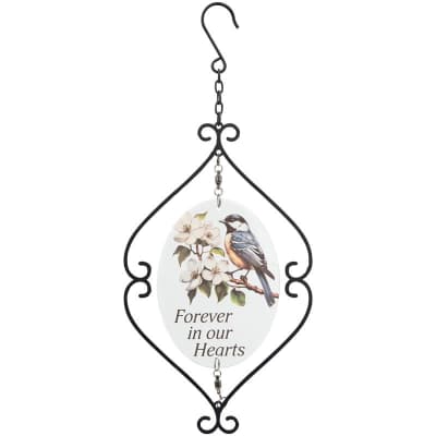 Hanging memorial plaque with bird and white blossoms inside a black metal scroll frame