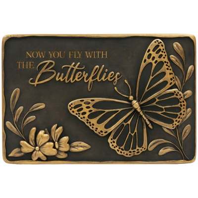 Bronze-colored memorial plaque with butterfly, flowers, and the words Now you fly with the butterflies.
