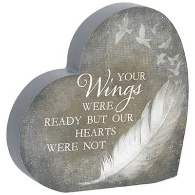Heart-shaped gray plaque with feather and birds illustration and white memorial text.