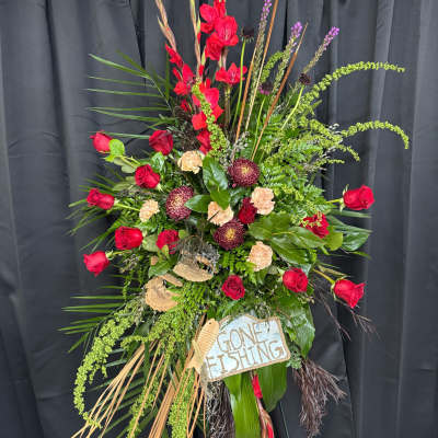 Tall floral standing spray with red roses and mixed greenery