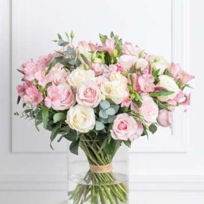 Pink and white rose bouquet in a clear glass vase